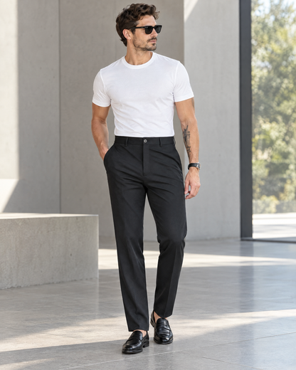 Men's black stretch slim straight dress pants styled with white tee and loafers