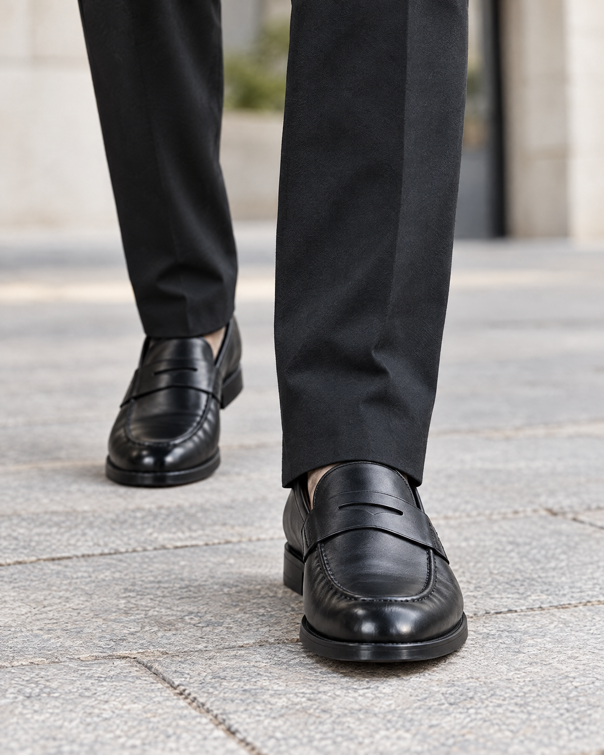 Sutton black stretch trousers hem over black leather loafers