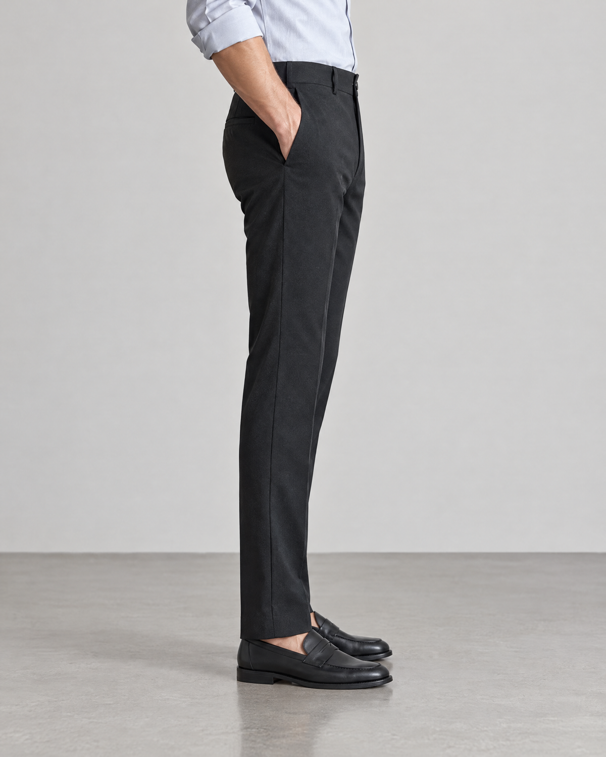 Side view of Sutton men's slim straight black dress pants with loafers