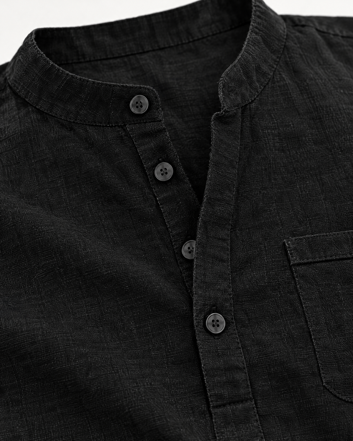 Close-up of Alden men's black linen blend henley button placket and band collar