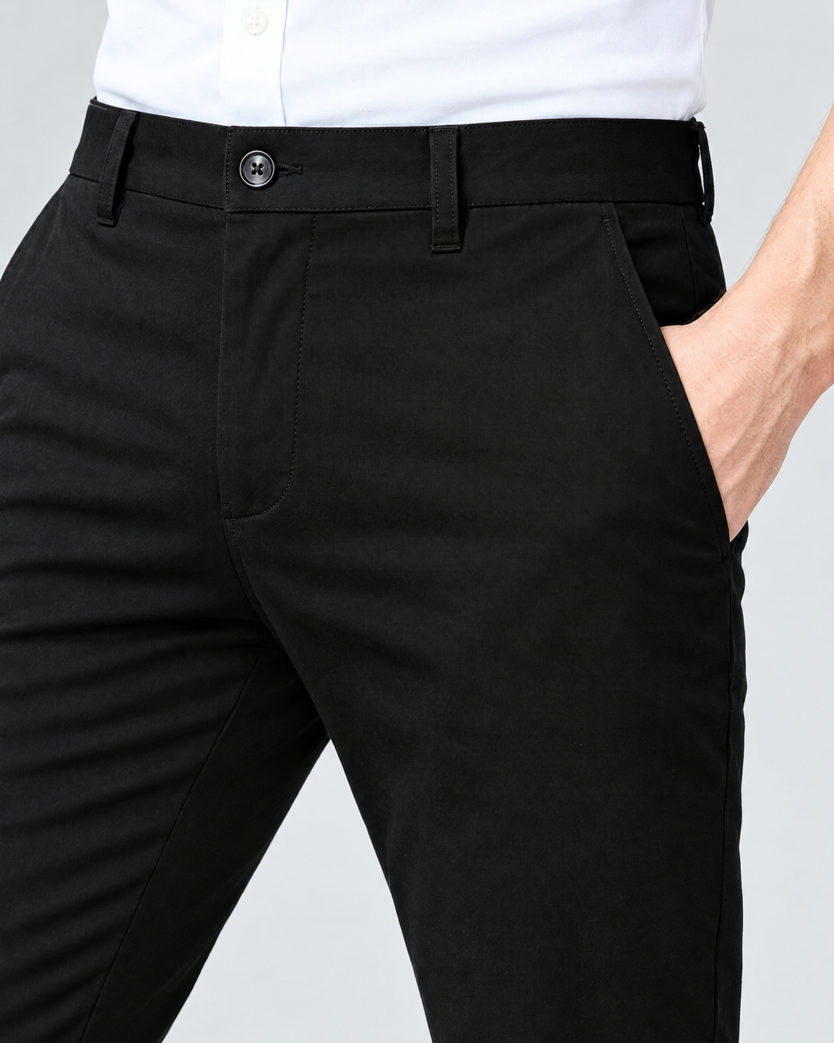 Waistband, button and belt loops of men's black stretch chino pants