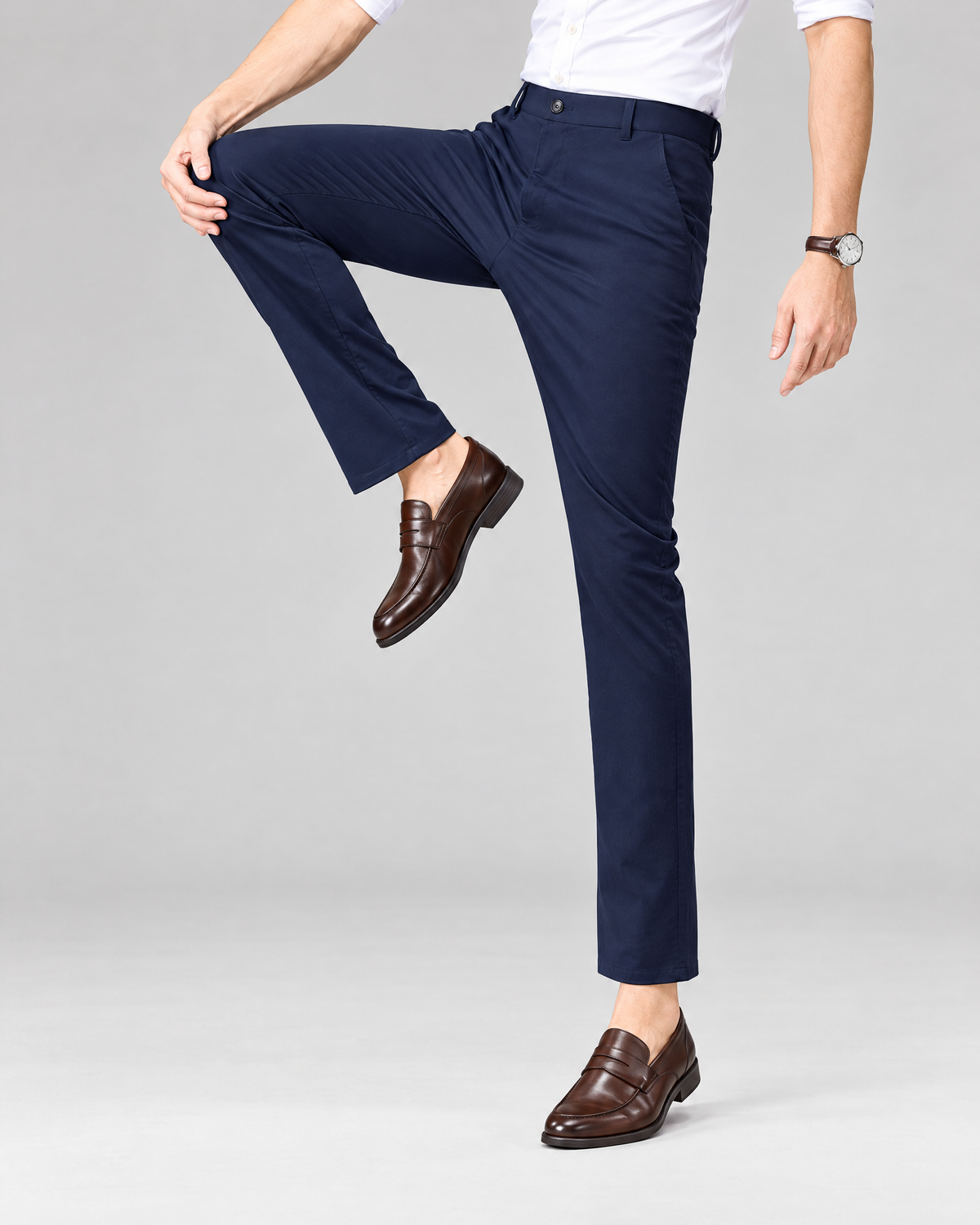 Men's navy blue stretch chino dress pants with white shirt and brown loafers
