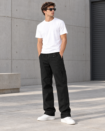 Men's black loose fit straight leg cargo pants with side pockets styled with white tee and sneakers