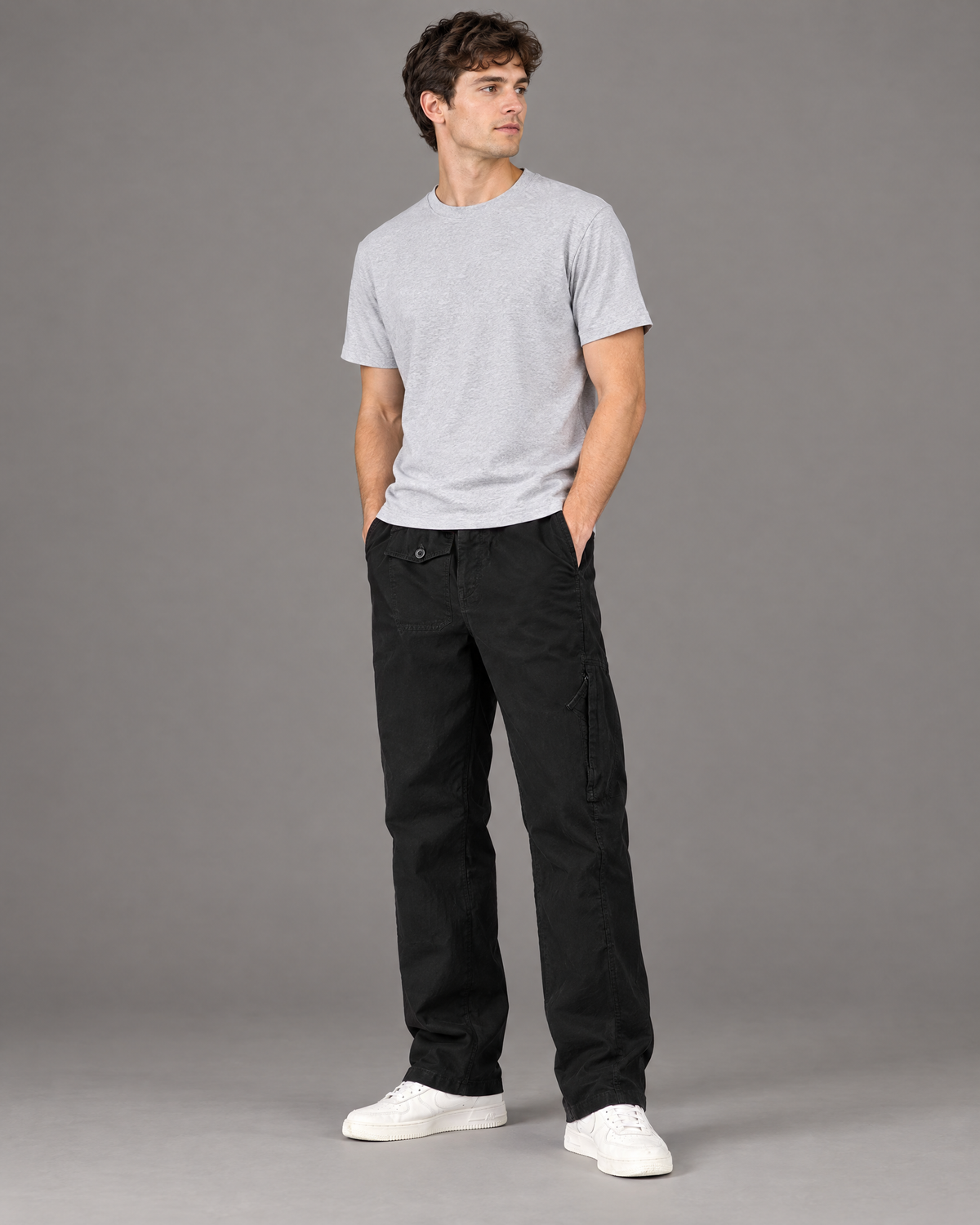 Black cotton cargo pants for men, loose fit, studio full length view
