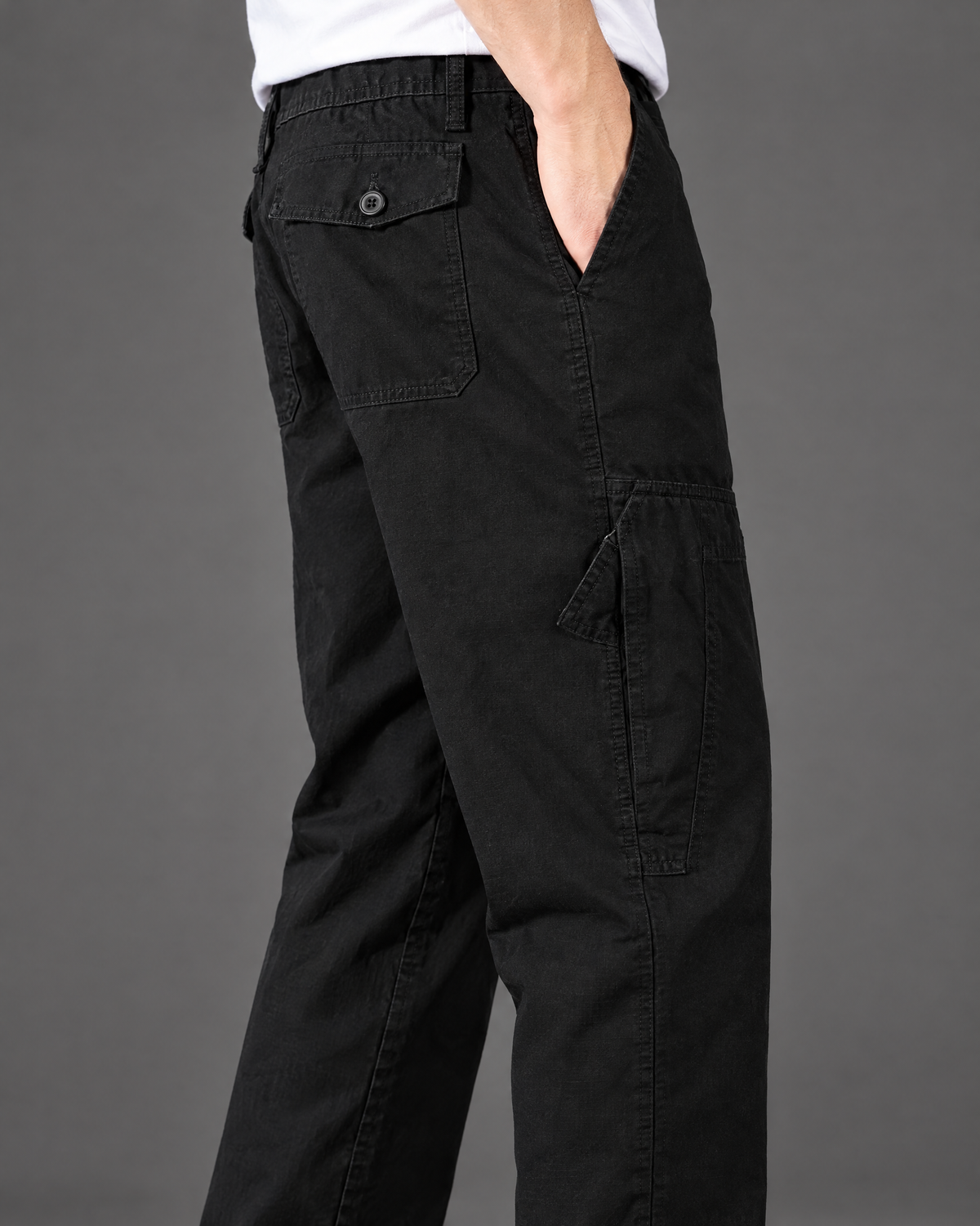 Side cargo pocket detail on men's black straight leg cargo pants